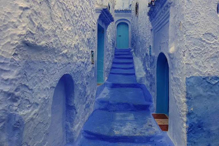 A blue-washed stairway and doorways in the medina of Chefchaouen