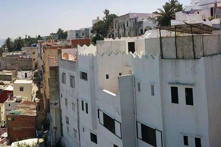 White houses and rooftop terraces of the Tangier medina in bright sun