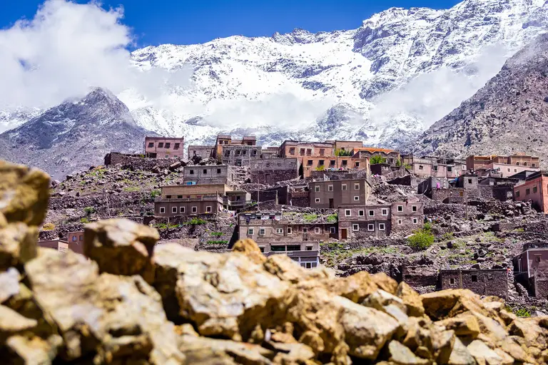 An earthen village below the snow-capped peaks of the High Atlas